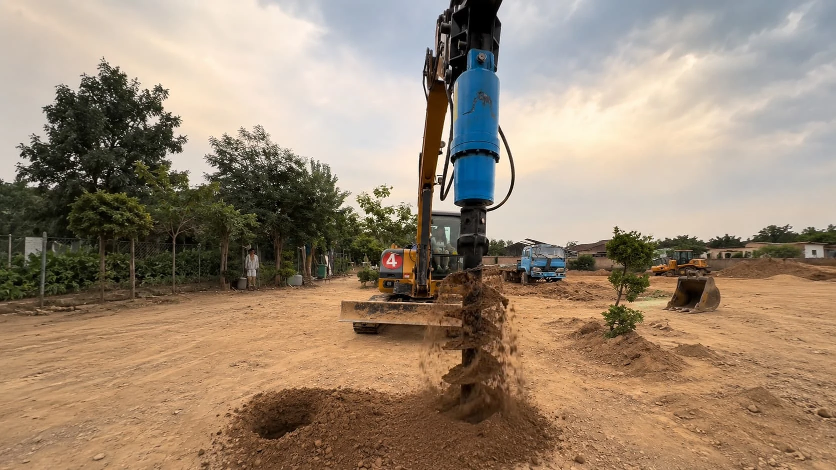 FEROX hydraulic auger drill boring post holes on site